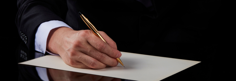 Man writing with the Classic Century 23KT Gold-Plated Mechanical Pencil.
