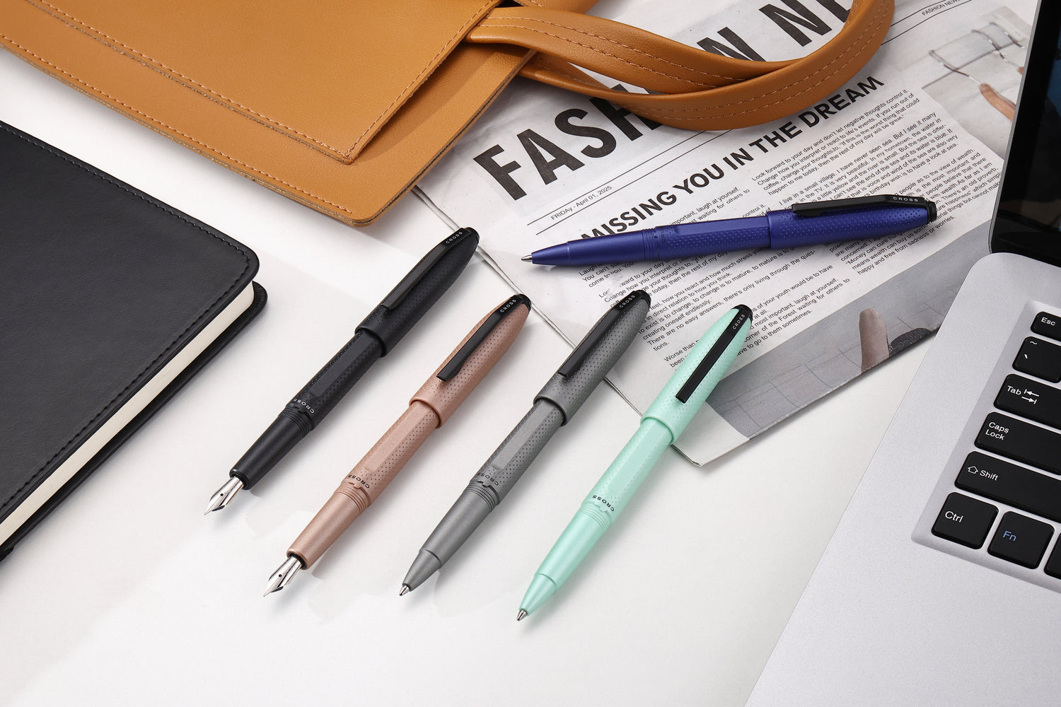Hand writing with the Coventry Medalist Ballpoint Pen, featuring a polished chrome finish with gold-tone accents.