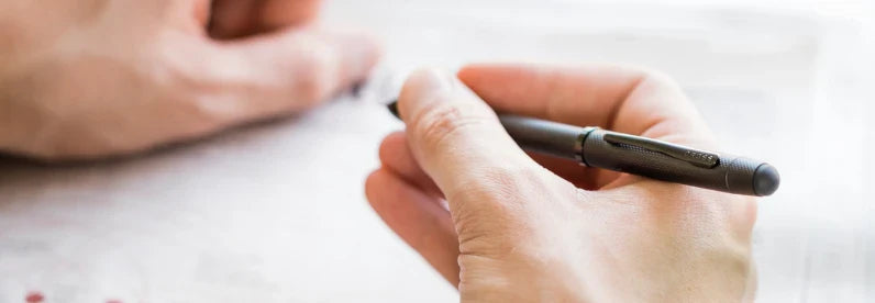 Man holding the Tech3+ Brushed Black PVD Pen.